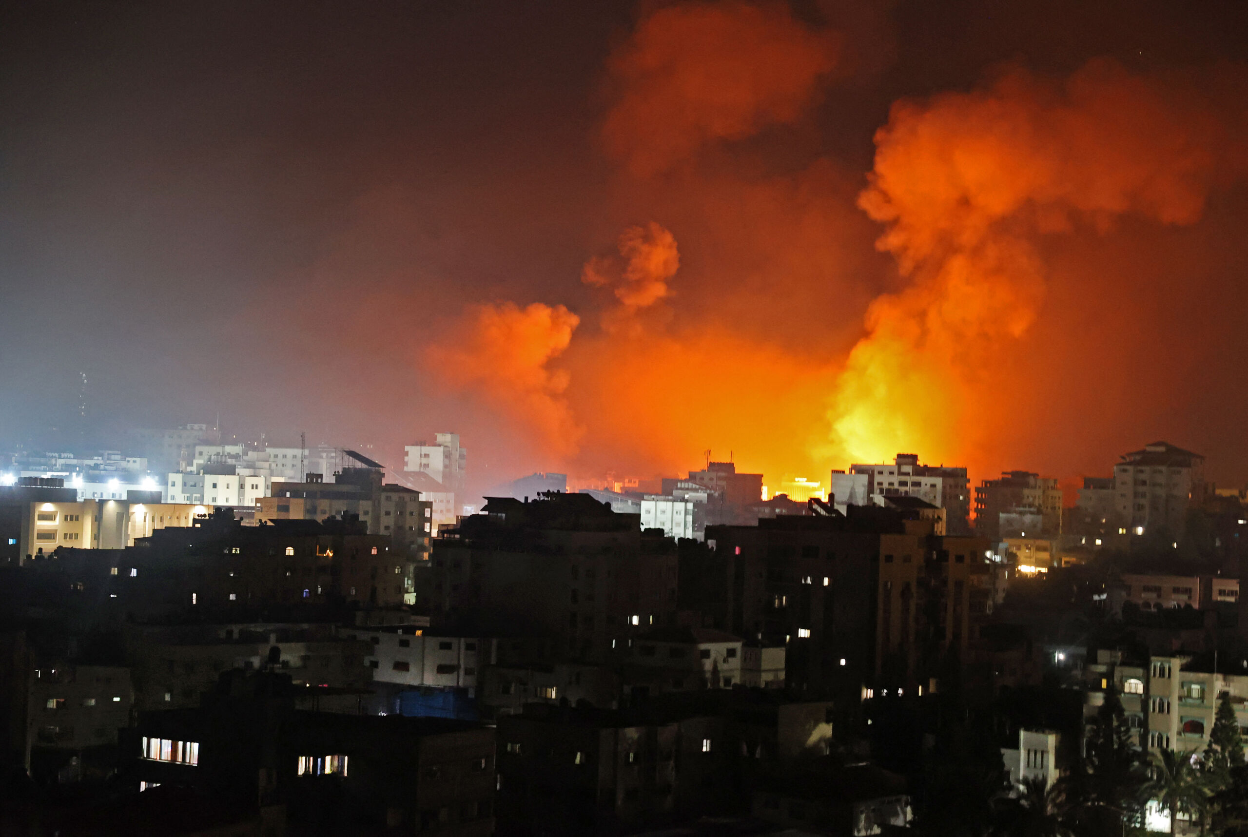 Fire erupts from the Andalus Tower as it is destroyed by an Israeli airstrike in Gaza City, controlled by the Palestinian Hamas movement, early on May 16, 2021. Israel pummelled the Gaza Strip with air strikes, killing 10 members of an extended family and demolishing a building housing international media outlets, as Palestinian militants fired back barrages of rockets. MOHAMMED ABED / AFP