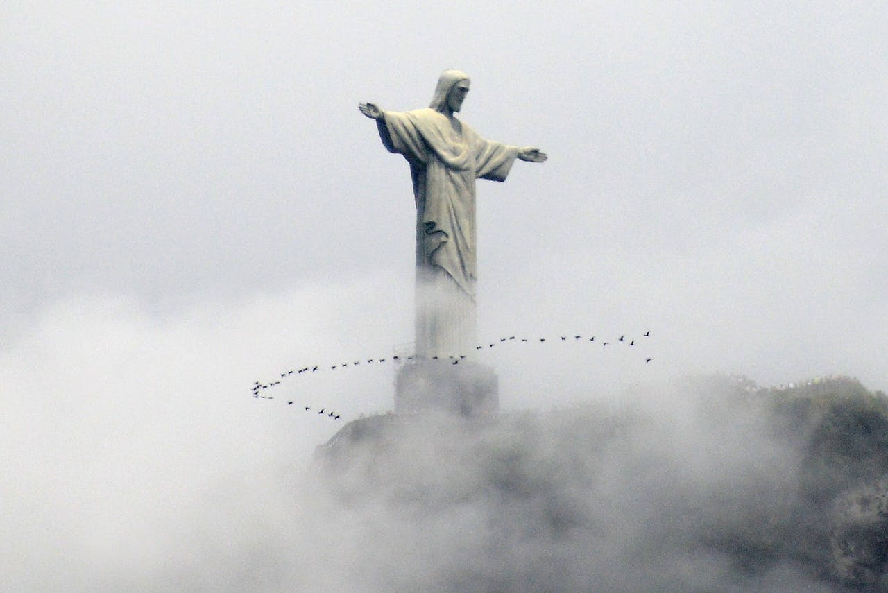 Vogels omcirkelen het beroemde beeld Christus de Verlosser in Brazilië. GABRIEL BOUYS / AFP