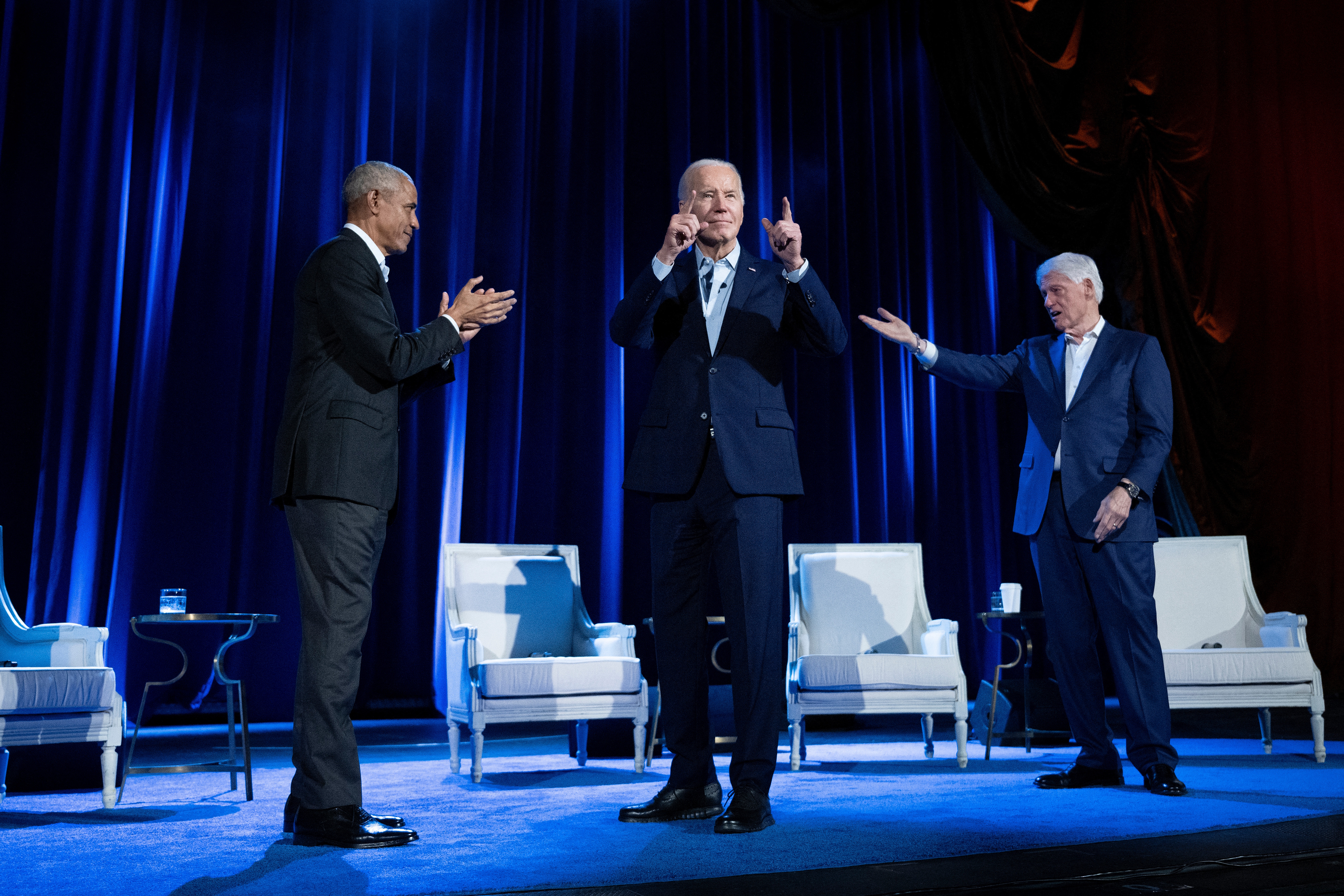 Former US President Barack Obama (L) and former US President Bill Clinton (R) cheer on US President Joe Biden during a fundraising event for his campaign at Radio City Music Hall in New York City on March 28, 2024. Brendan Smielowski/AFP