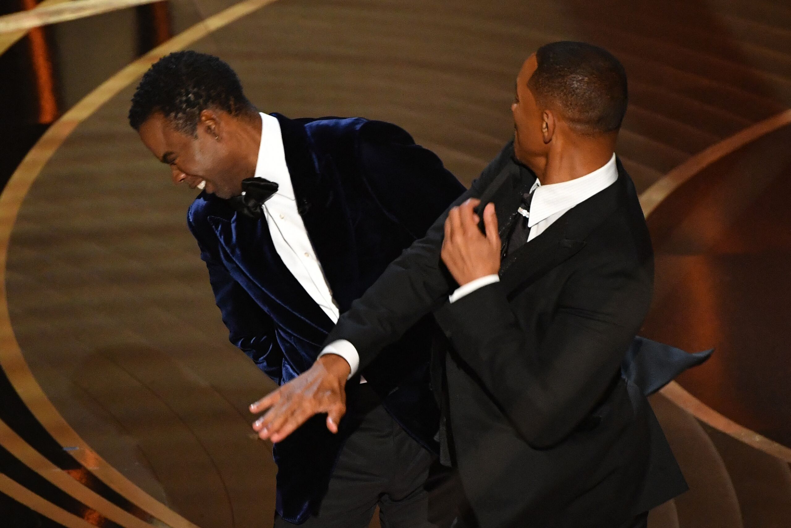 US actor Will Smith (R) slaps US actor Chris Rock onstage during the 94th Oscars at the Dolby Theatre in Hollywood, California on March 27, 2022.   Robyn Beck / AFP