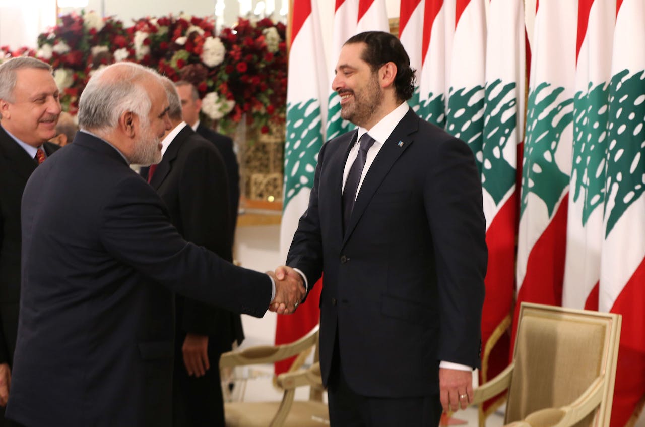 2017-11-22 14:46:00 Iranian ambassador to Lebanon Mohammad Fathali shakes hands with lebanese prime minister Saad Hariri during a ceremony at the presidential palace in Baadba on November 22, 2017 as Lebanon celebrates Independence Day marking 74 years since the end of France's mandate in Lebanon. Hariri said today he had agreed to suspend his decision to resign, at the request of President Michel Aoun, pending talks on the political situation. / AFP PHOTO / STRINGER