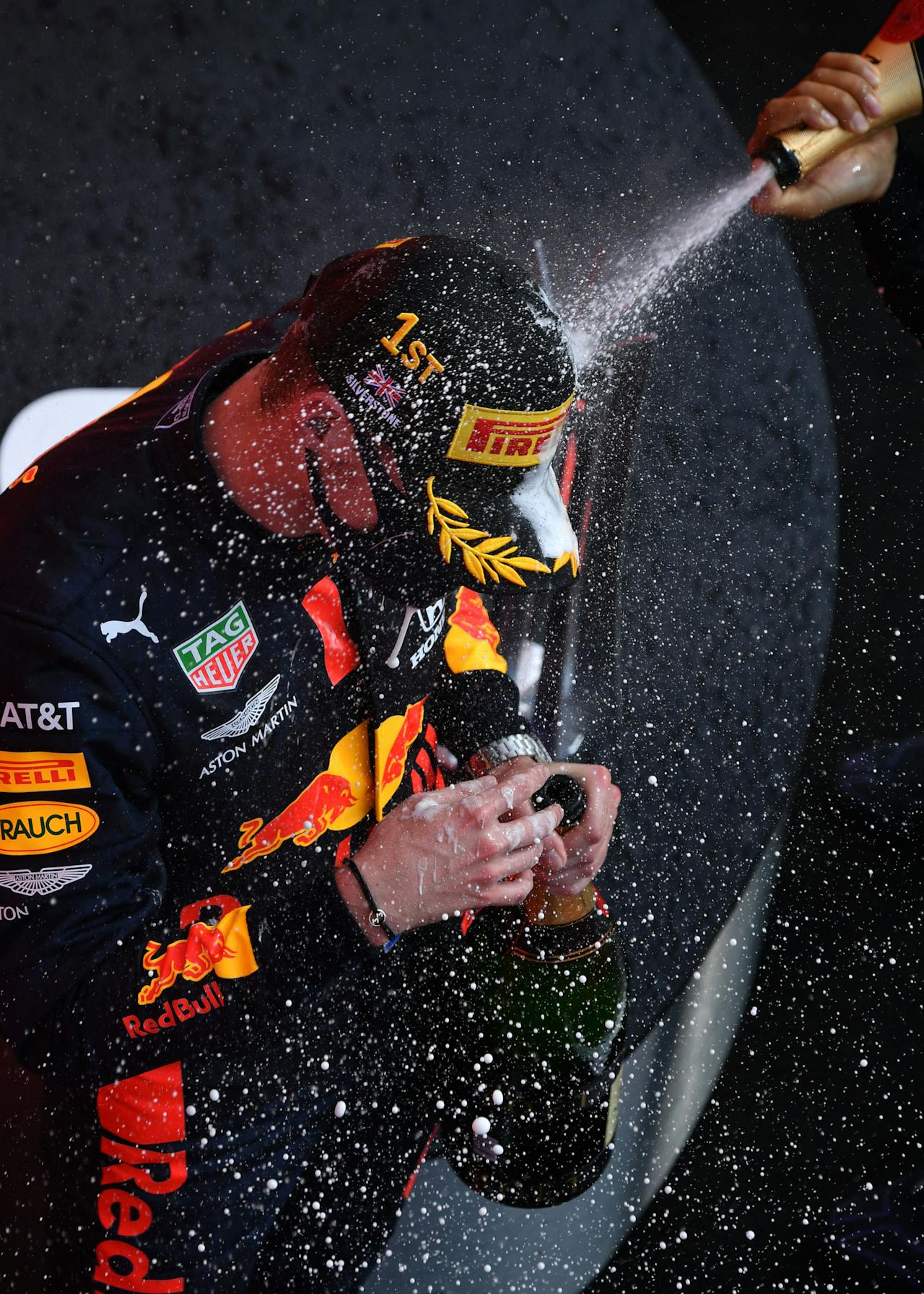 2020-08-09 16:57:41 Winner Red Bull's Dutch driver Max Verstappen (L) is sprayed with champagne by second plaved Mercedes' British driver Lewis Hamilton (R) during the F1 70th Anniversary Grand Prix at Silverstone on August 9, 2020 in Northampton. The race commemorates the 70th anniversary of the inaugural world championship race, held at Silverstone in 1950. Ben STANSALL / POOL / AFP