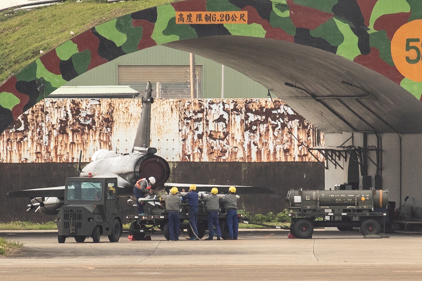 epa10564499 Air Force personnel load missiles to arm a Mirage 2000 fighter jet inside the air base in Hsinchu, Taiwan, April 8, 2023. China announced three days of military exercises around Taiwan and dozens of aircraft flew across the middle line of the Taiwan Strait on April 8, after which .  Visit of the President of Taiwan to the United States.  EPA/Ritchie B.  Tongo