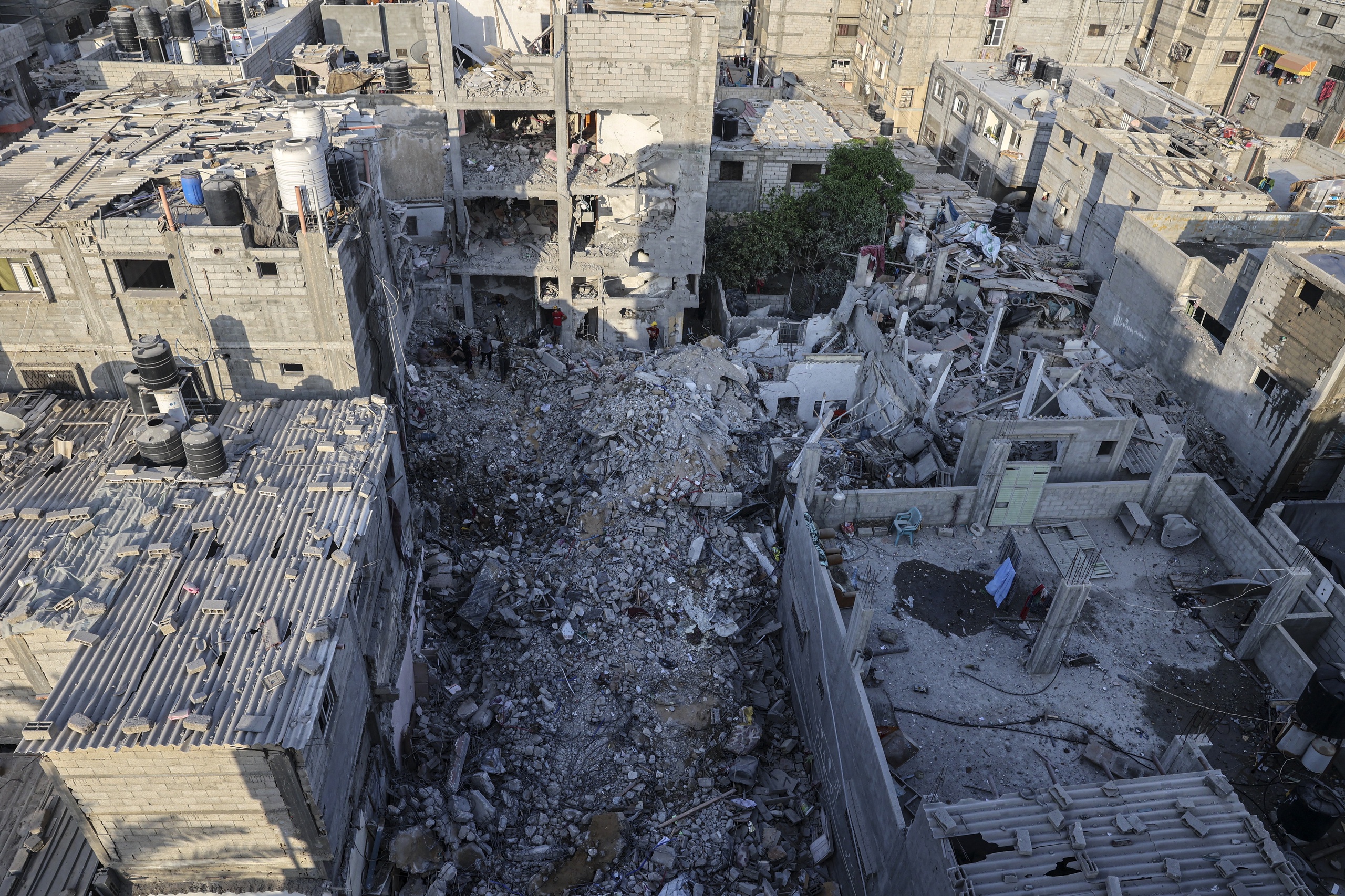 Palestinians search through the rubble of a building in which Khaled Mansour, a top Islamic Jihad militant died according to his movement, following an overnight Israeli air stike in Rafah in the southern Gaza strip, on August 7, 2022.  SAID KHATIB / AFP