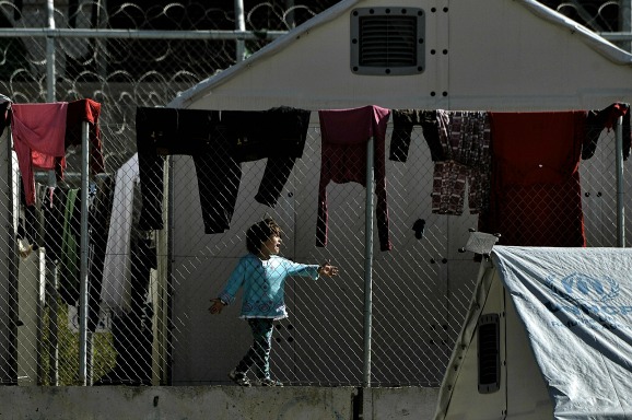 Een kind achter de hekken van detentiecentrum Moria op Lesbos. Foto ANP