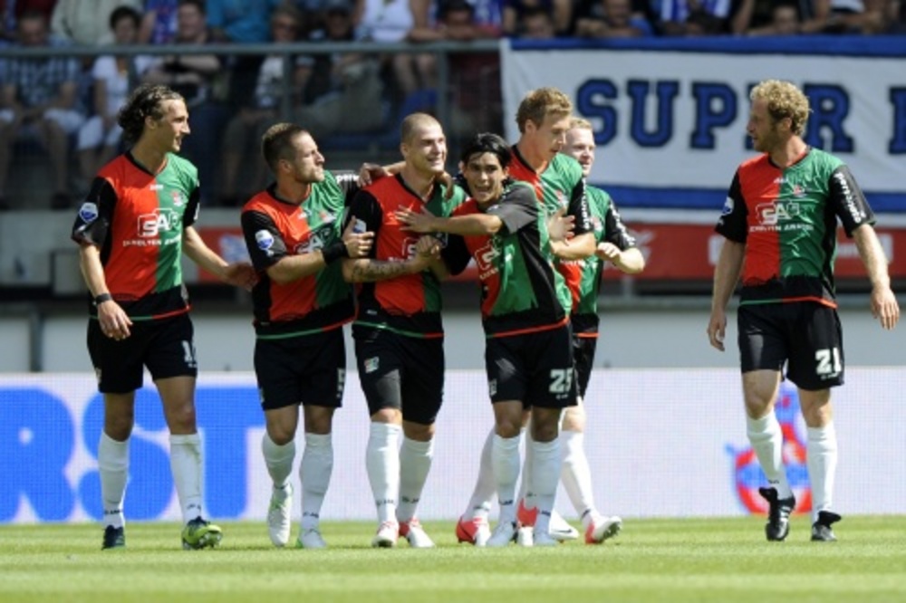 De spelers van NEC vieren de 0-2 van Pavel Cmovs (derde van links) tegen sc Heerenveen. ANP