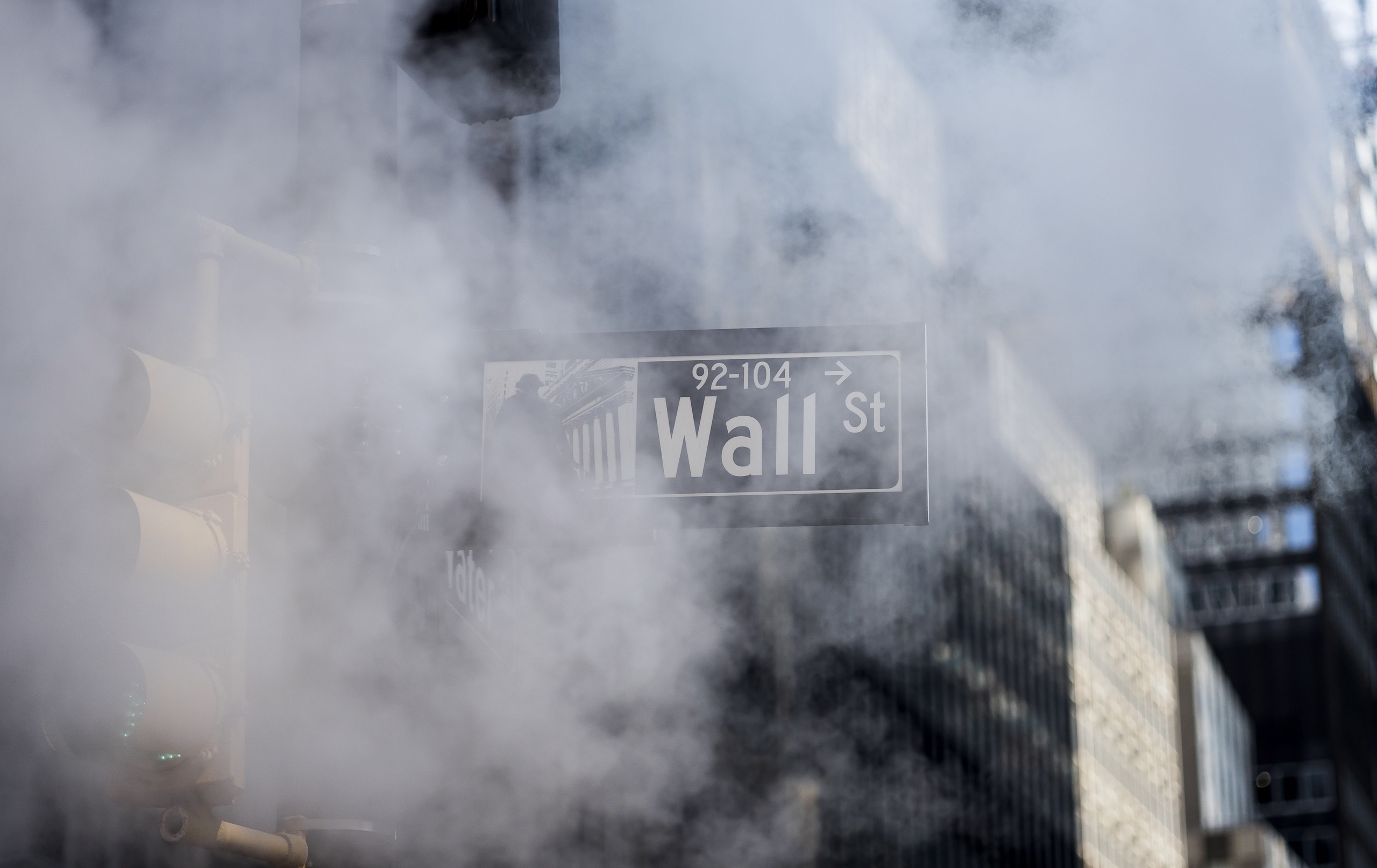 epa10105823 A street sign for Wall Street obscured by steam from a manhole near the New York Stock Exchange in New York, New York, USA, 04 August 2022.  EPA/JUSTIN LANE