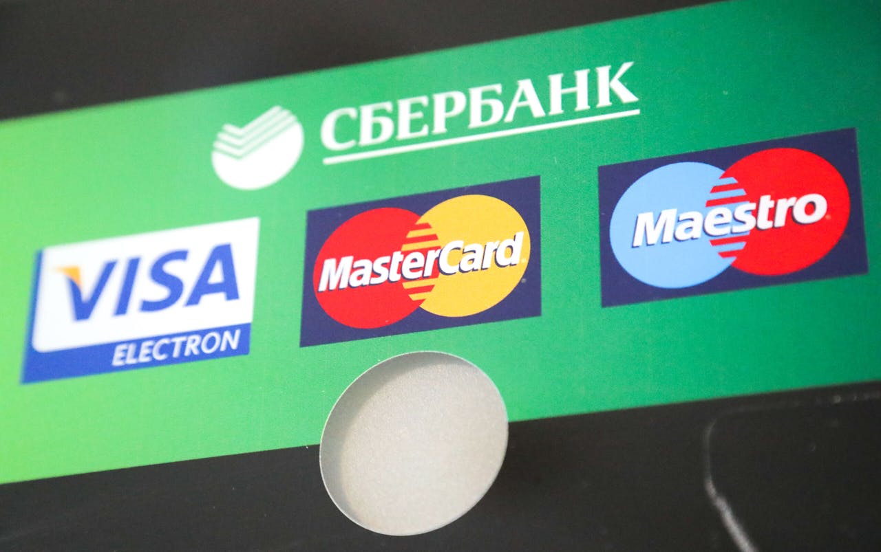 06 March 2022, Russia, St. Petersburg: The Visa, Mastercard and Maestro logos can be seen on a Sberbank ATM. Photo: Igor Grussak/dpa Photo via Newscom