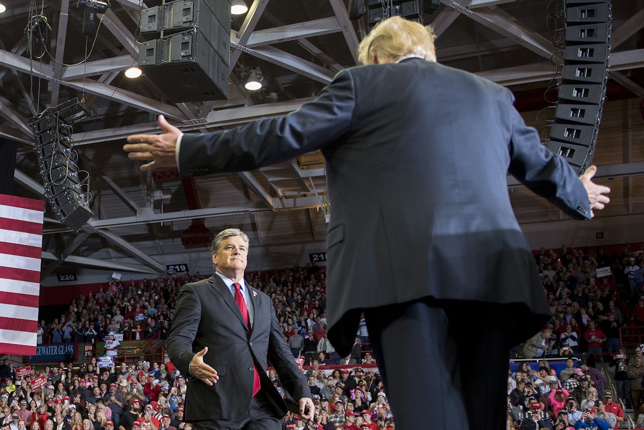 2018-11-06 05:28:57 US President Donald Trump greets talk show host Sean Hannity at a Make America Great Again rally in Cape Girardeau, Missouri on November 5, 2018. Jim WATSON / AFP