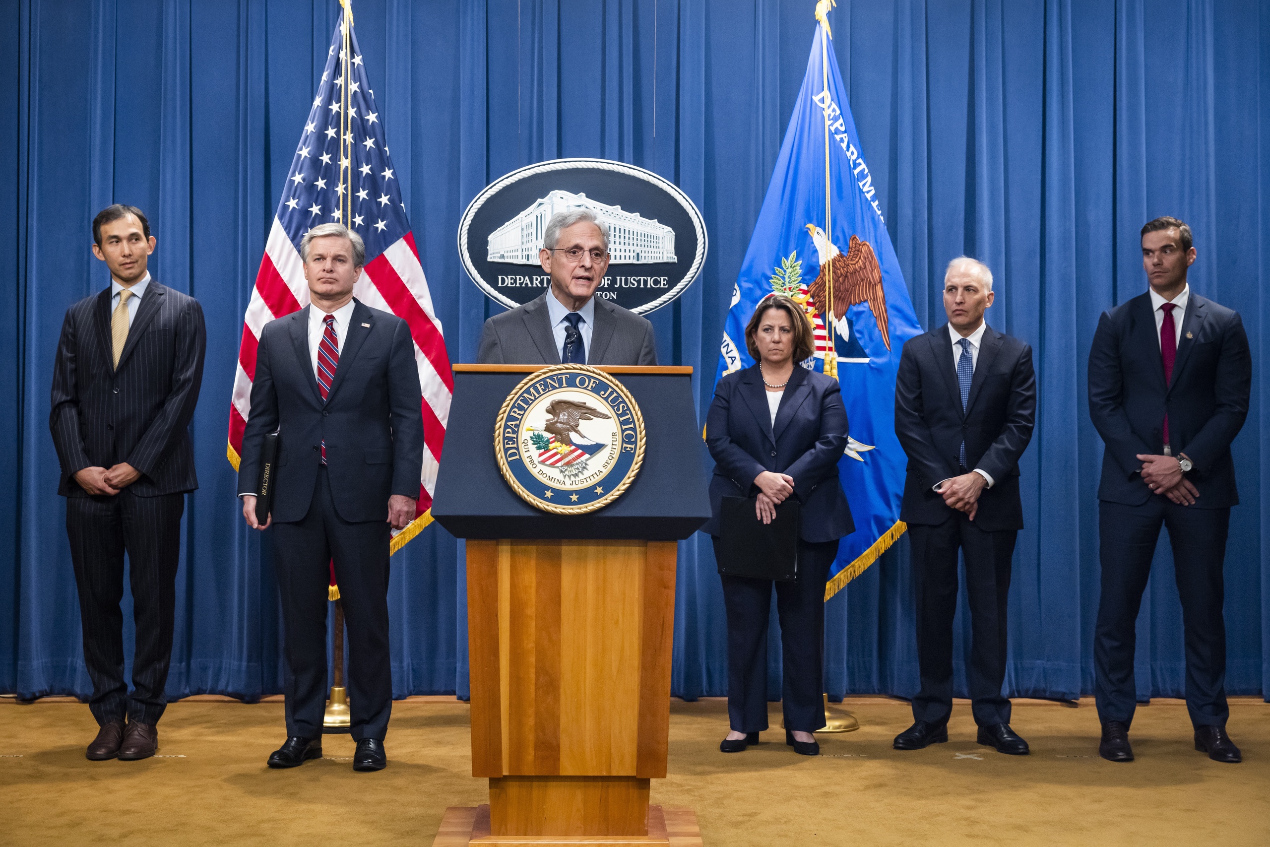 epa10263548 US Attorney General Merrick B. Garland (C), flanked by Deputy Attorney General Lisa O. Monaco (C-R) and FBI Director Christopher Wray (C-L), speaks to the media about national security cases addressing 'malign influence schemes' from China at the Department of Justice in Washington, DC, USA, 24 October 2022.  EPA/JIM LO SCALZO