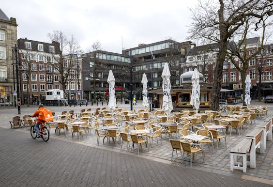 Een leeg terras in het centrum van Den Haag nadat horeca gesloten is vanwege maatregelen tegen het coronavirus.