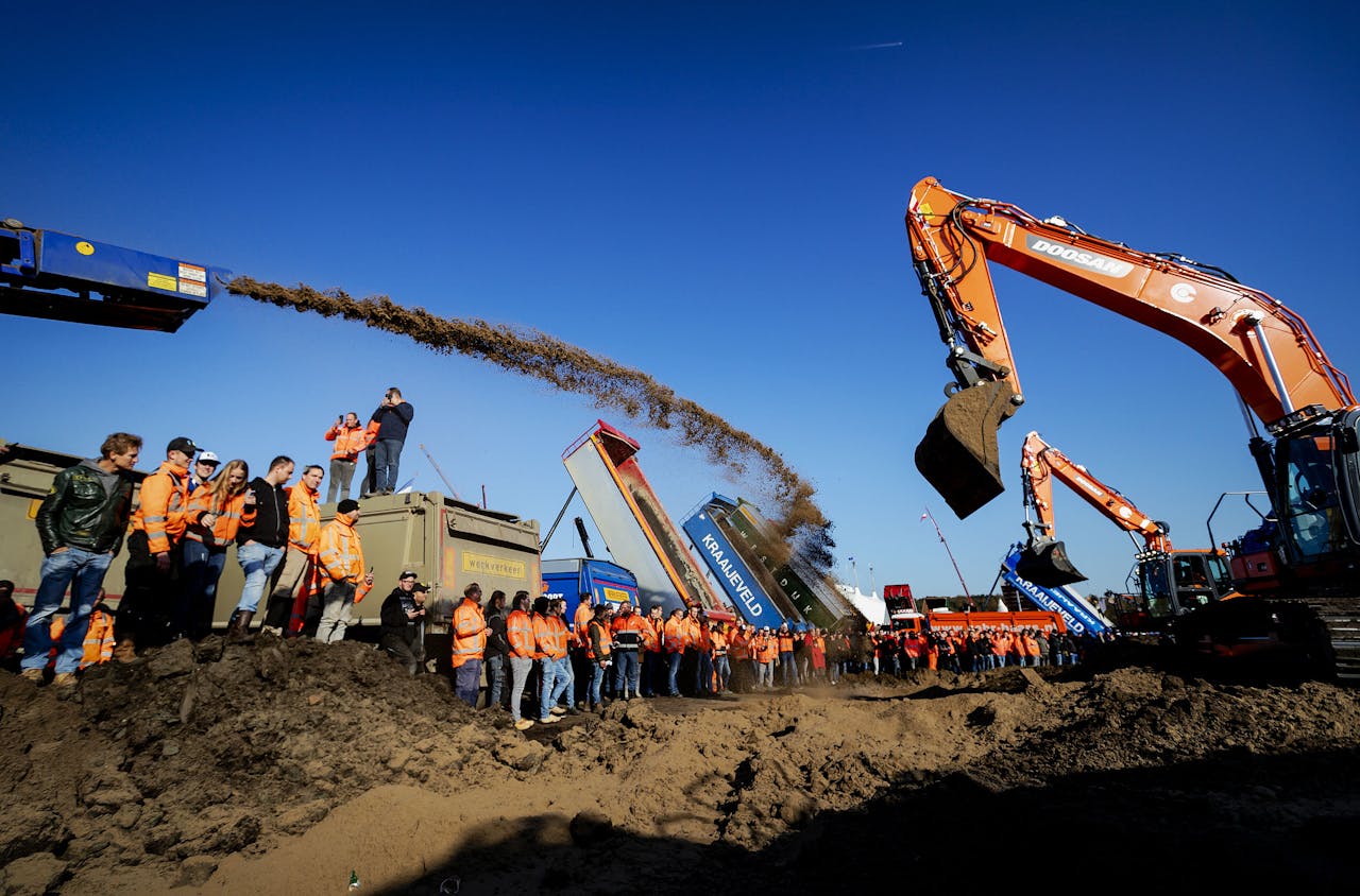 Bouwers storten grond op het Malieveld tijdens een ludieke actie tijdens het bouwprotest Grond in Verzet. Bouwers en transporteurs demonstreren met shovels en hijskranen tegen het stikstofbeleid.