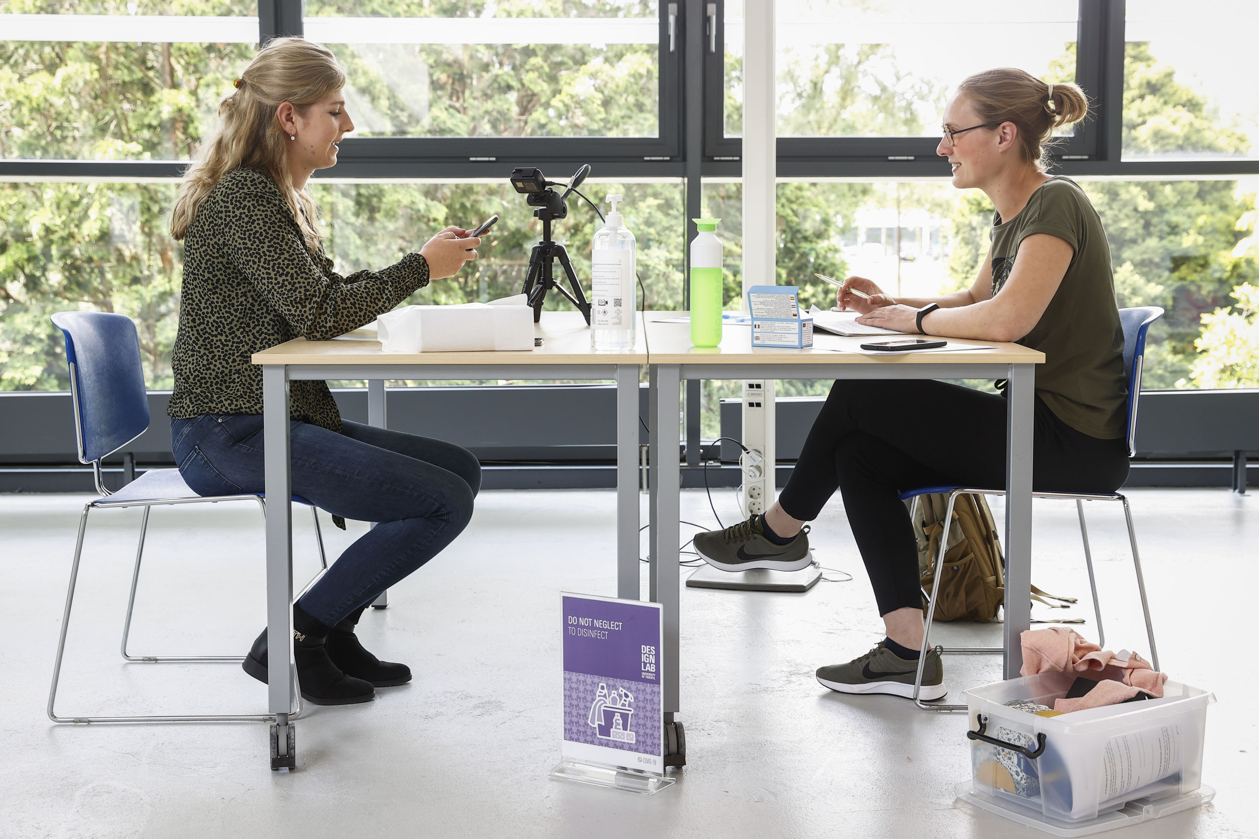 Jongeren testen in een lab van de Universiteit Twente een coronawaarschuwingsapp.