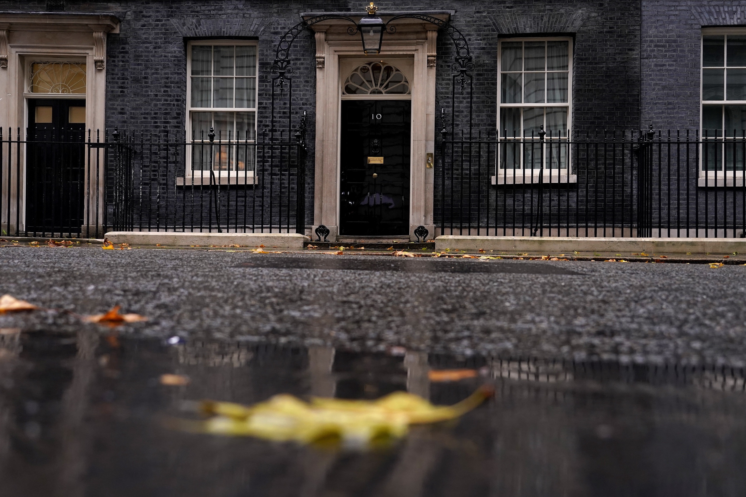 Rain and fallen leaves create an autumn atmosphere at 10 Downing Street in London, Thursday, Oct. 20, 2022. U.K. Prime Minister Liz Truss is hanging on to power by a thread after a senior minister quit her government and a vote in the House of Commons descended into chaos and acrimony. (AP Photo/Alberto Pezzali)
